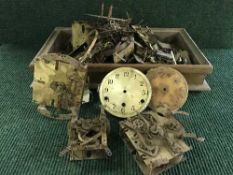 A box of clock parts and movements etc