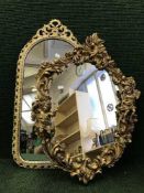 A decorative gilt framed cherub wall mirror together with cream and gilt hall table with mirror