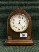 An inlaid mahogany arched topped mantel clock