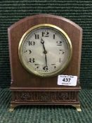 A mahogany mantel clock on brass bracket feet