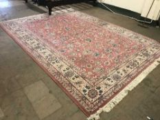 A large Kashan design carpet on pink ground