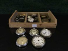 A wooden box of assorted pocket watches, desk clock, protractors,