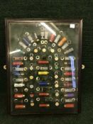A framed shotgun shell montage