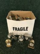 A box of miniature desk clocks