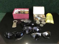 A collection of coins and a box of key rings, badges, lighters,