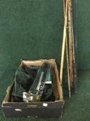 A small quantity of split cane spinning rods together with a box of landing net, fishing book,