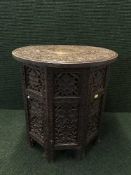 A heavily carved Moorish style folding table