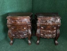 A pair of carved mahogany commode chests