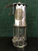 A chrome and brass Eccles Protector miner's lamp