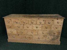 A pine multi drawer chest fitted twenty two drawers
