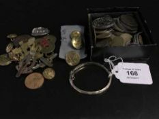 A collection of coins to include a George III penny, commemorative coins, silver bangle,