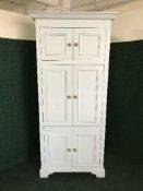 A painted pine door storage cupboard