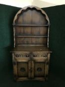 A carved oak kitchen dresser