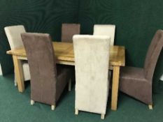 An oak extending dining table with leaf and six suede high back chairs