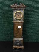A late 19th century oak miniature long case clock