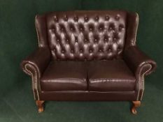 A Chesterfield style armchair and matching two seater settee