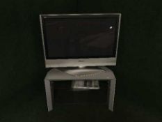 A Panasonic 37 inch plasma TV on stand with remote