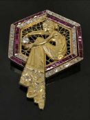 A fine gold, diamond and ruby set brooch, depicting a lady in flowing dress holding a diamond,