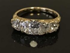 An 18ct gold diamond set ring, the stones within a carved setting, estimated to weigh a total of 1.