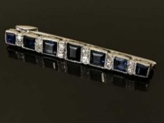 A diamond and sapphire bar brooch, the total sapphire weight estimated at 2.