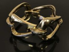 A two-tone 18ct gold hinged bracelet, stamped 750 at the clasp, length 21cm, weight 79.