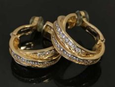 A fine pair of 18ct gold and diamond set hoop earrings by Cartier,