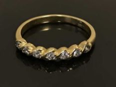 An 18ct gold diamond set half-eternity ring