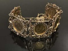 A highly decorative 9ct gold panel bracelet set with five full Sovereigns dated 1894, 1897, 1915,