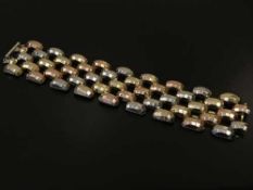 A three-tone yellow metal bracelet, with indistinct foreign marks, length 20.5cm, weight 62.