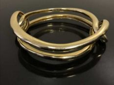 An 18ct gold bangle by Cartier, 70.