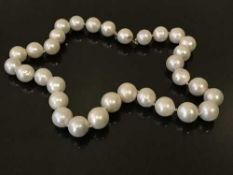A large cultured pearl necklace, strung with 32 pearls averaging approximately 13mm in diameter,