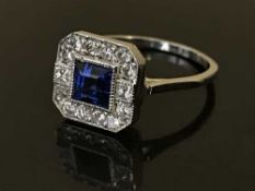 A sapphire and diamond set cluster ring, the sapphire etsimated to weigh 0.72 carat, the diamonds 0.