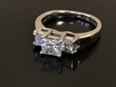 A 14ct gold and platinum three stone princess-cut diamond ring