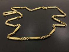 A continental gold necklace of barrel design, indistinctly stamped,