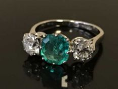 A fine platinum diamond and emerald ring, the emerald estimated to weigh 1.39 carat, the diamonds 1.