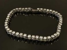 An 18ct white gold diamond line bracelet, the total diamond weight estimated at 4.4 carats, 12.