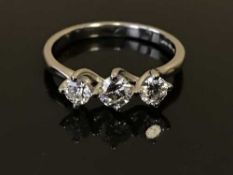 A platinum three stone diamond ring