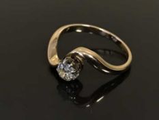 A diamond solitaire ring on yellow metal shank
