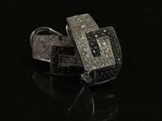 A pair of 9ct white gold black and white diamond earrings (2)