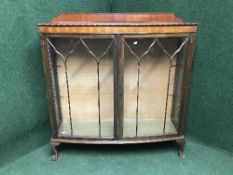 A mahogany double door display cabinet on claw and ball feet