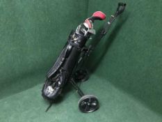 A folding golf trolley with bags together with a set of Pro-Dyn irons,