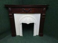 A decorative mahogany fire surround with a fibre glass Adams style insert