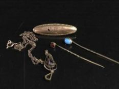 A gold and agate brooch and a gold and garnet set brooch