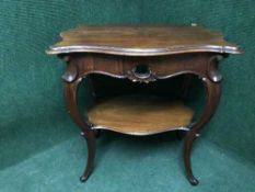 An ornate carved occasional table