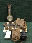 A tray of carved oak barometer, carved table lamp, wooden bowls, camera, leather gloves,