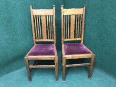 A pair of Edwardian oak rail backed chairs