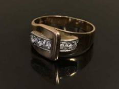 A diamond set buckle ring,