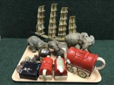 A tray of three piece English pottery wagon teapot, milk jug and basin, elephant figures,