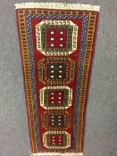 A fringed Persian design carpet runner