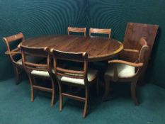 An inlaid yew wood twin pedestal dining table with leaf and six chairs
